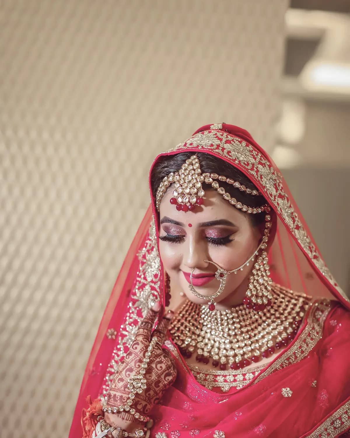 Bride in a red and gold sari with traditional jewellery